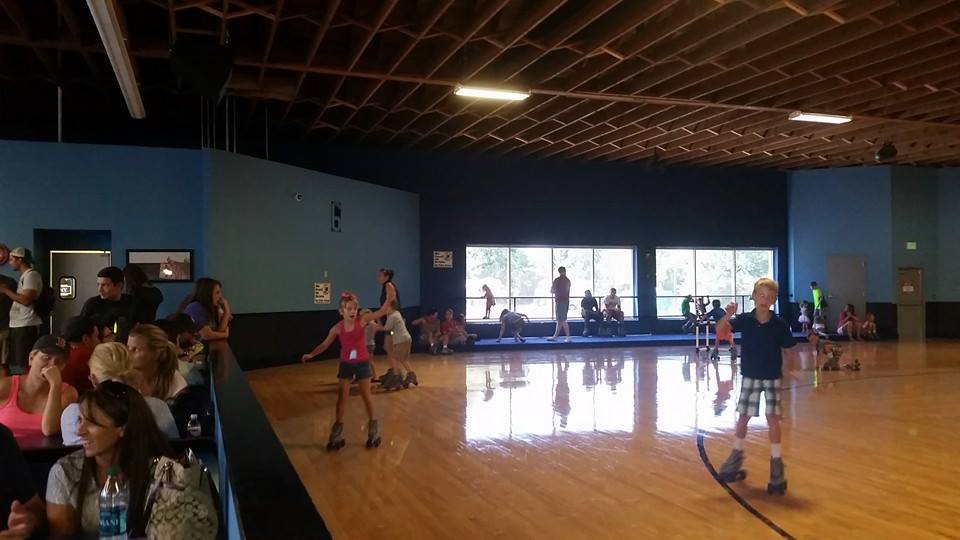 children skating on hardwood floor