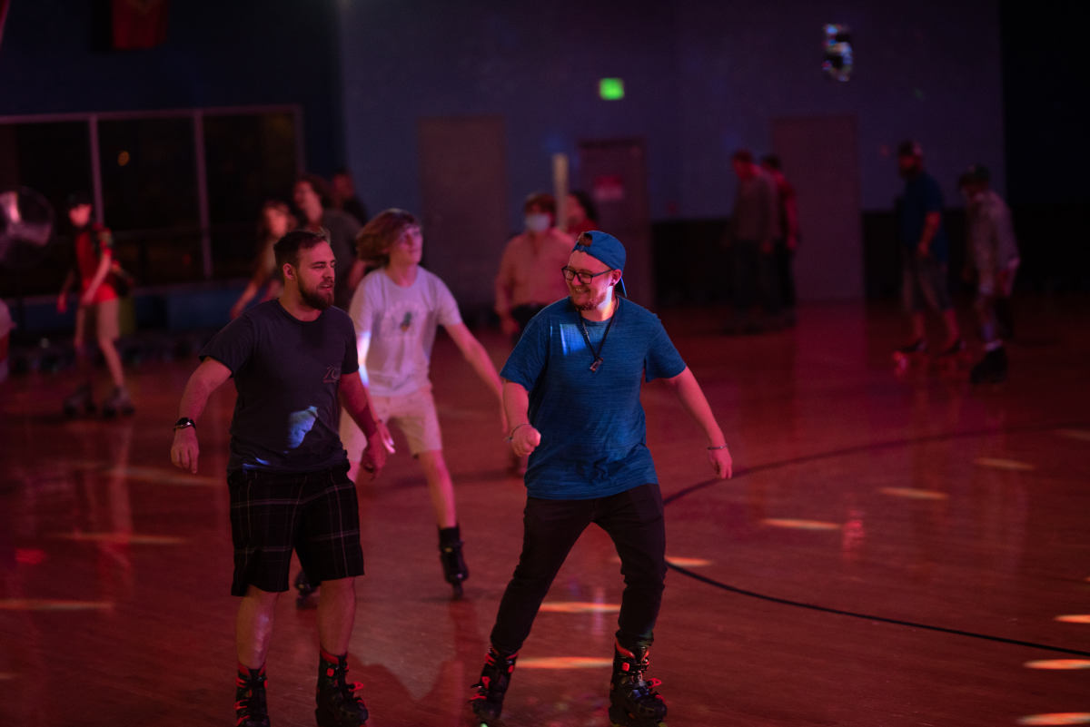 image of 2 young men skating on rollerblades